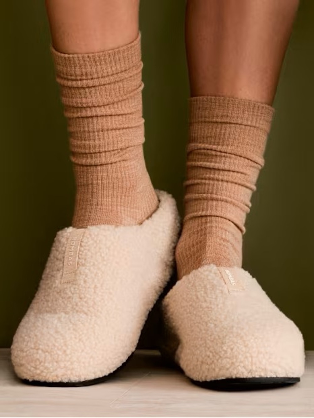 Bombas Cream Sherpa Slip-On Slippers with Tan Socks Visible